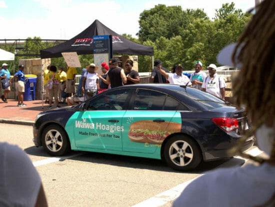 When Duana Malcolm had her blue Hyundai Sonata sedan 'wrapped' as a mobile advertising board, the part-time delivery driver did not expect to make an extra