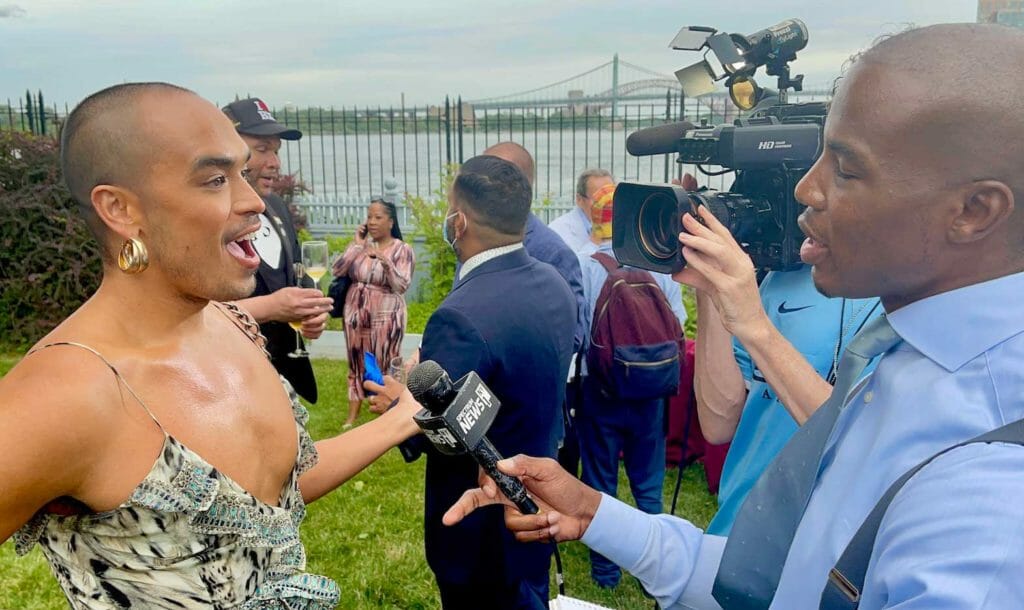 Fil-Australian Seann Miley Moore of ‘X Factor UK’ fame (left) being interviewed by TV reporter at Mayor Adams’ PRIDE reception. INQUIRER/Elton Lugay 
