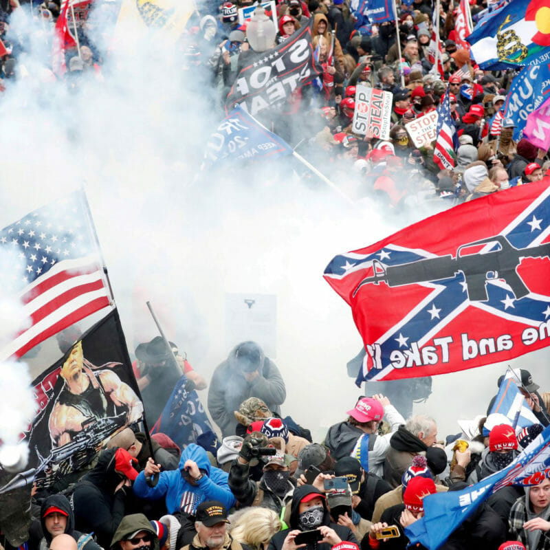 Tear gas is released into a crowd of protesters, with one wielding a Confederate battle flag that reads "Come and Take It," during clashes with Capitol police at a rally to contest the certification of the 2020 U.S. presidential election results by the U.S. Congress, at the U.S. Capitol Building in Washington, U.S, January 6, 2021. REUTERS/Shannon Stapleton/File Photo