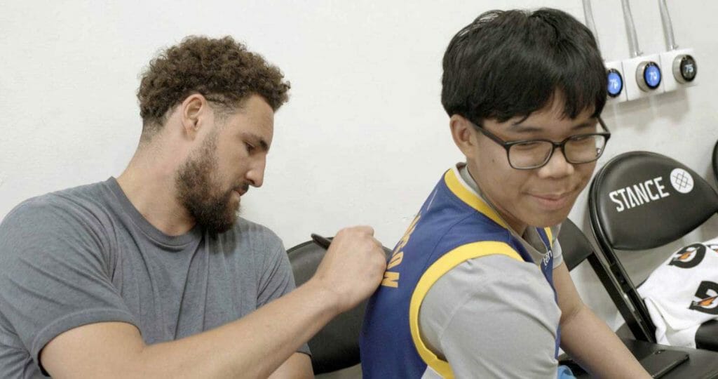  Golden State Warriors all-star Klay Thompson signs a T-shirt for Joseph Tagaban, a 15-year-old from Petersburg, Alaska, who was diagnosed with acute myeloid leukemia in December 2020. Tagaban and Thompson are featured in the ESPN series “My Wish,” which aired Wednesday. (Courtesy ESPN) 