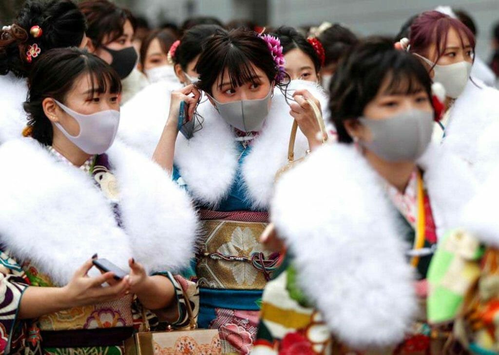 Kimono-clad youth wearing protective face masks leave their Coming of Age Day celebration ceremony at Yokohama Arena in Yokohama, south of Tokyo, Japan January 11, 2021. Mask wearing has never been an issue here, for the simple fact that pre-pandemic, many did routinely wear masks when in public. REUTERS FILE PHOTO