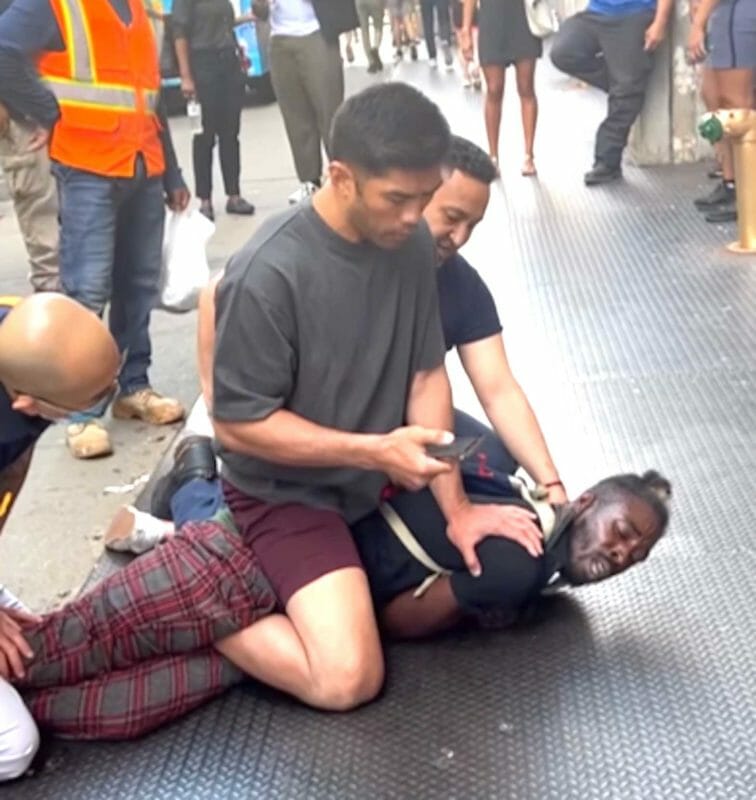 Ro Malabanan keeps suspect pinned down after stopping him from attacking more people on New York City street. INSTAGRAM