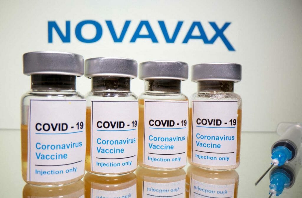 Vials with a sticker reading, "COVID-19 / Coronavirus vaccine / Injection only" and a medical syringe are seen in front of a displayed Novavax logo in this illustration taken October 31, 2020. REUTERS/Dado Ruvic/Illustration