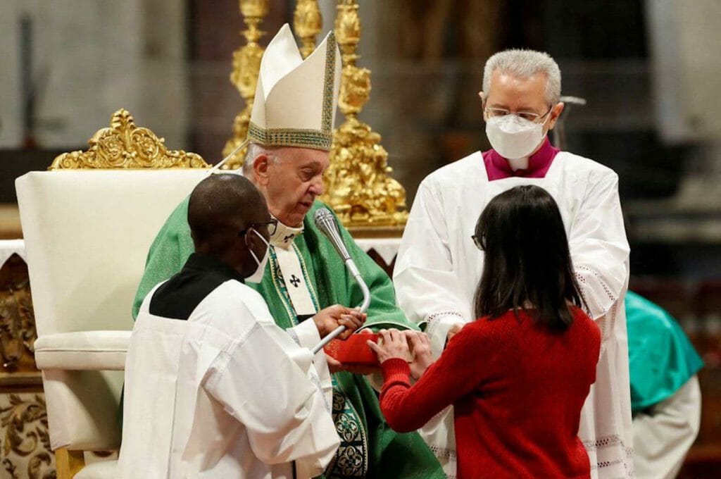 A new lector receives a gospel from Pope Francis during a Holy Mass held every year on the third Sunday of January to celebrate and study the Word of God, in St. Peter's Basilica at the Vatican, January 23, 2022. REUTERS/Remo Casilli