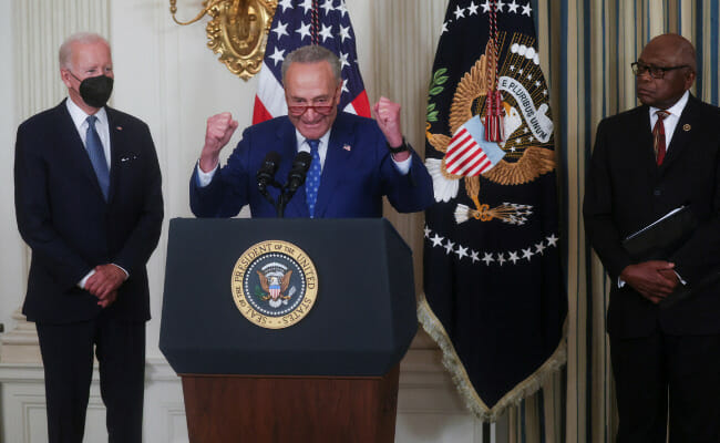 Biden signs inflation reduction act, hands pen to Manchin