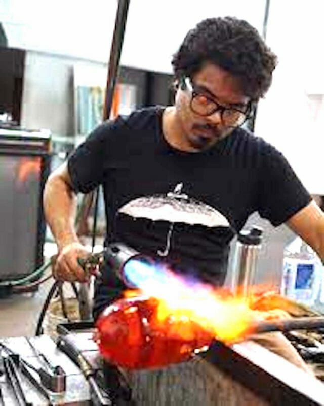 Glass-blowing artist Trenton Quicho at work in a hotshot. FACEBOOK