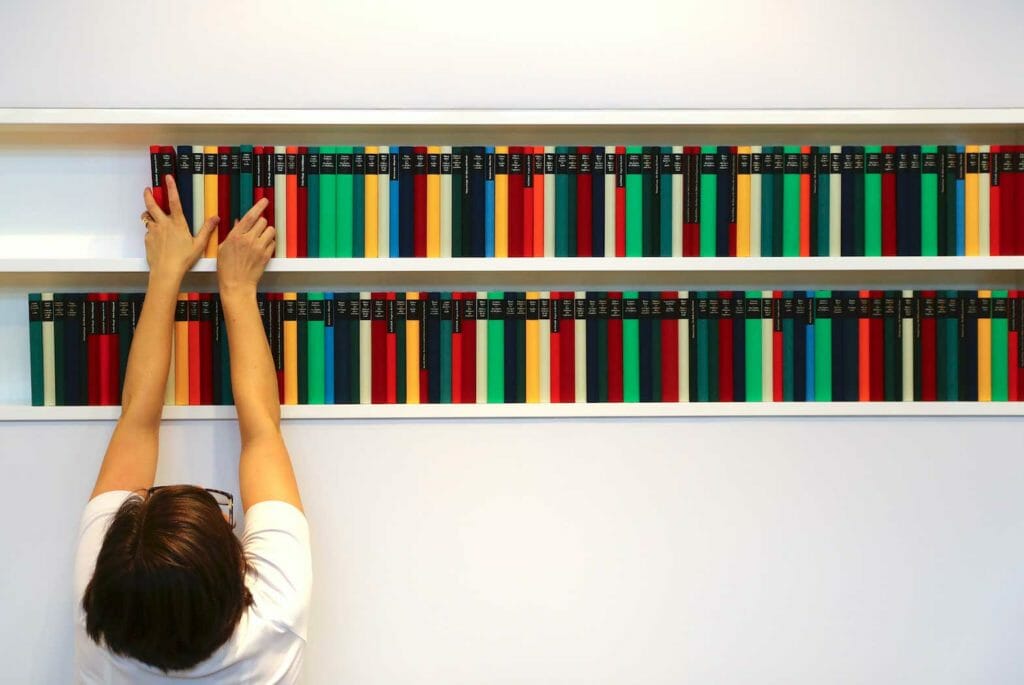 A woman arranges books in a file photo. REUTERS/Kai Pfaffenbach