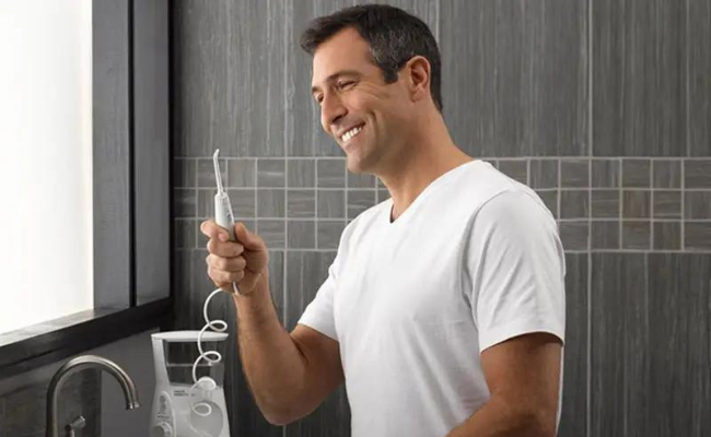 This is a person using a water flosser.