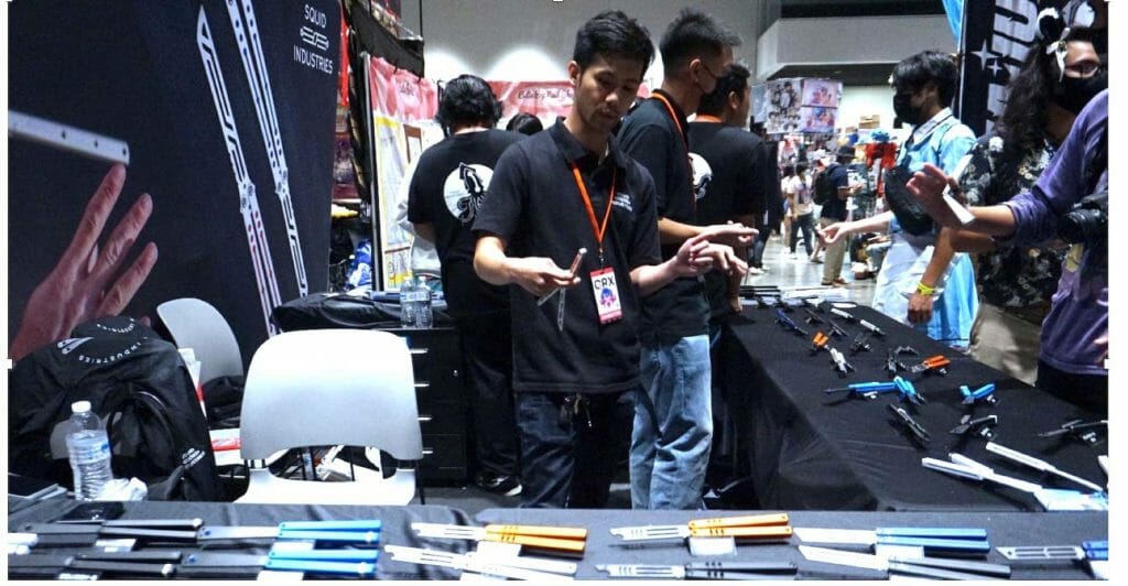 TV Huynh flipping a balisong trainer at Squid Industries’ Crunchyroll booth (ROBIN BARKIN)