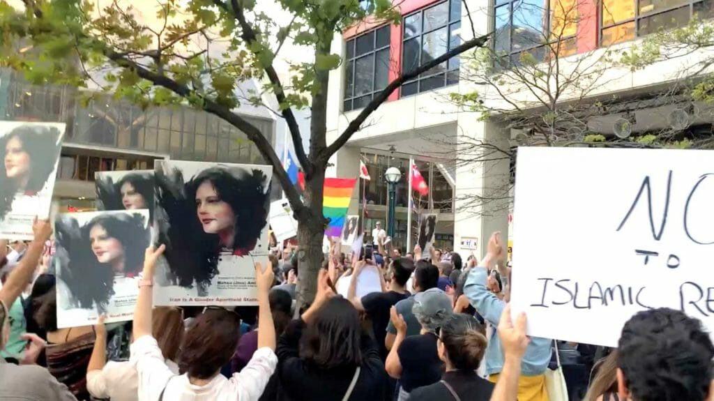 People attend a protest in Toronto, Canada, September 19, 2022, in solidarity with the women in Iran, following the death of Mahsa Amini, in this screen grab obtained from social media video obtained by REUTERS