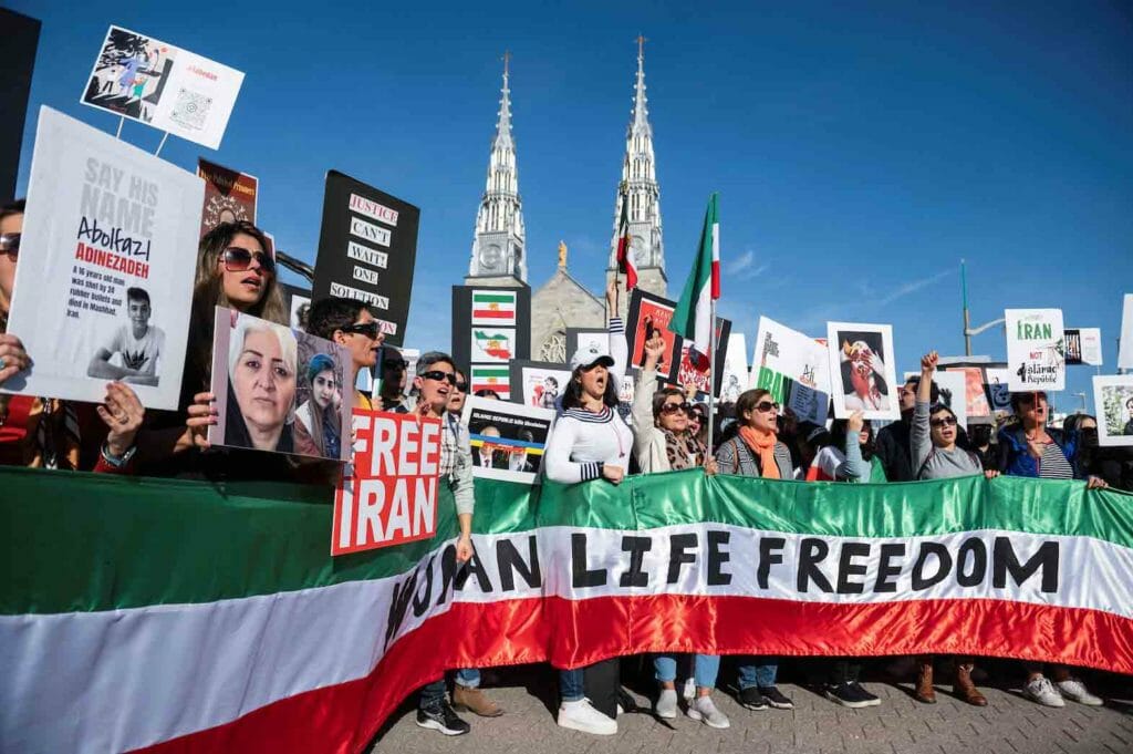 Protesters in support of women in Iran hold a banner reading 'Women Life Freedom' during a protest following the death of Mahsa Amini, in Ottawa, Ontario, Canada, October 29, 2022. REUTERS/Spencer Colby/File Photo