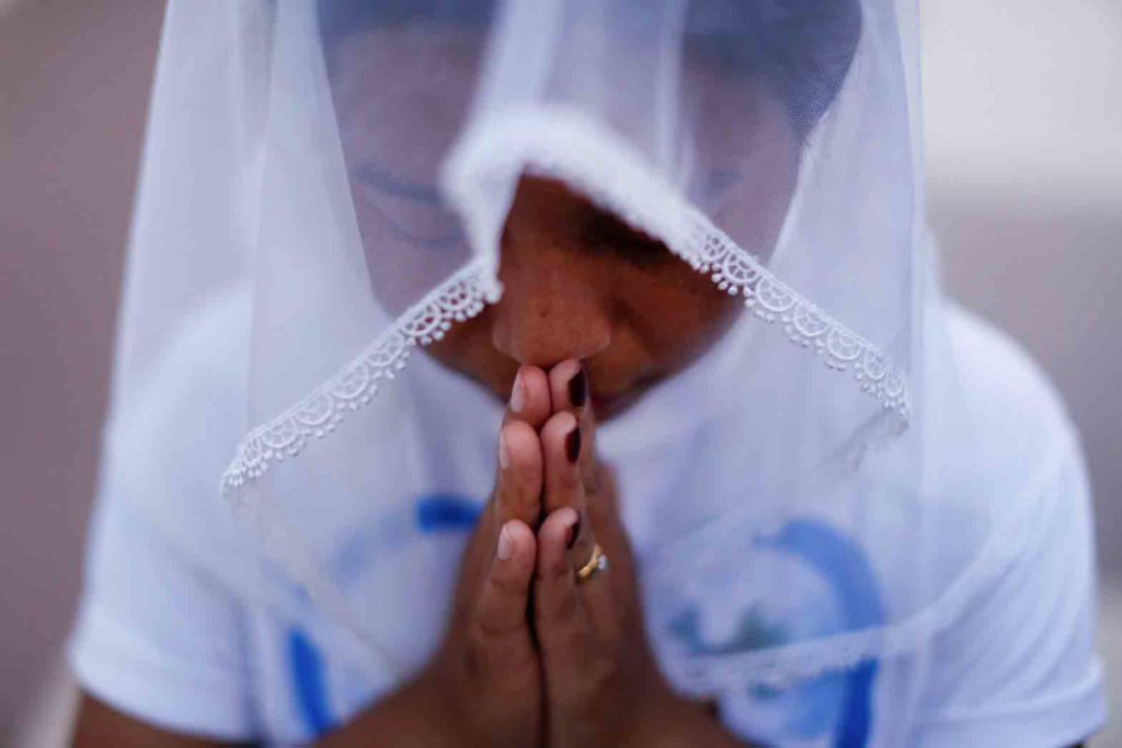 A woman is pictured in a file photo praying at St. Anthony church in Yangon, Myanmar. (CNS photo/Jorge Silva, Reuters)