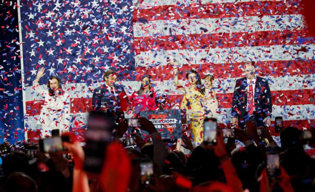 Republican Florida Governor Ron DeSantis is showered with confetti as he celebrates onstage with his wife Casey and family during his 2022 U.S. midterm elections night party in Tampa, Florida, November 8, 2022. REUTERS/Marco Bello