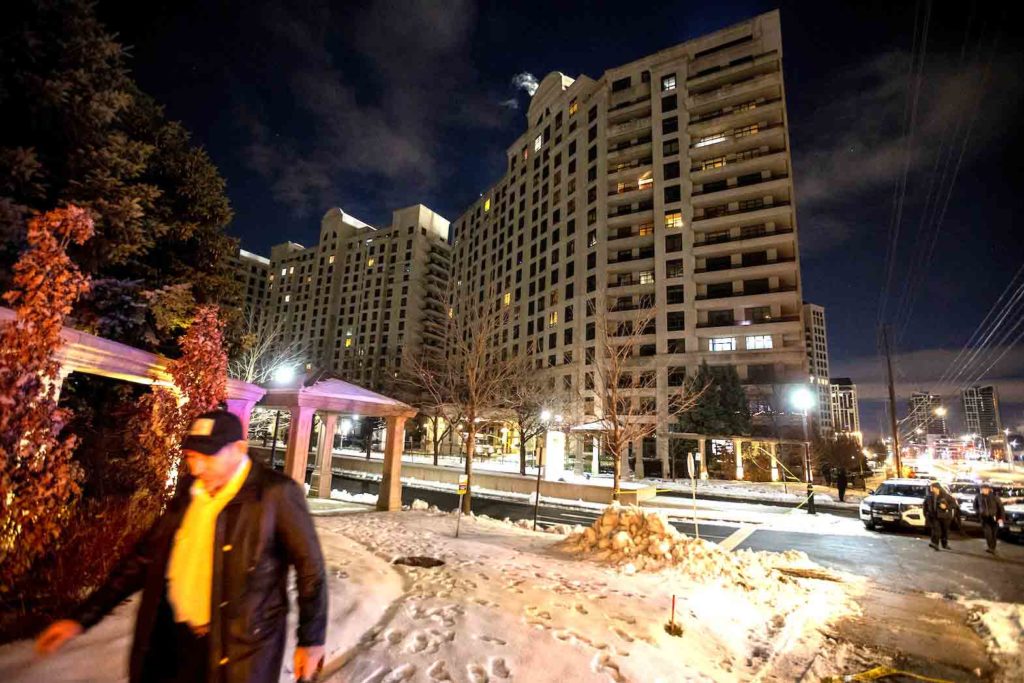 A person walks past the scene after a fatal mass shooting at a condominium building in the Toronto suburb of Vaughan, Ontario, Canada December 19, 2022. REUTERS/Carlos Osorio
