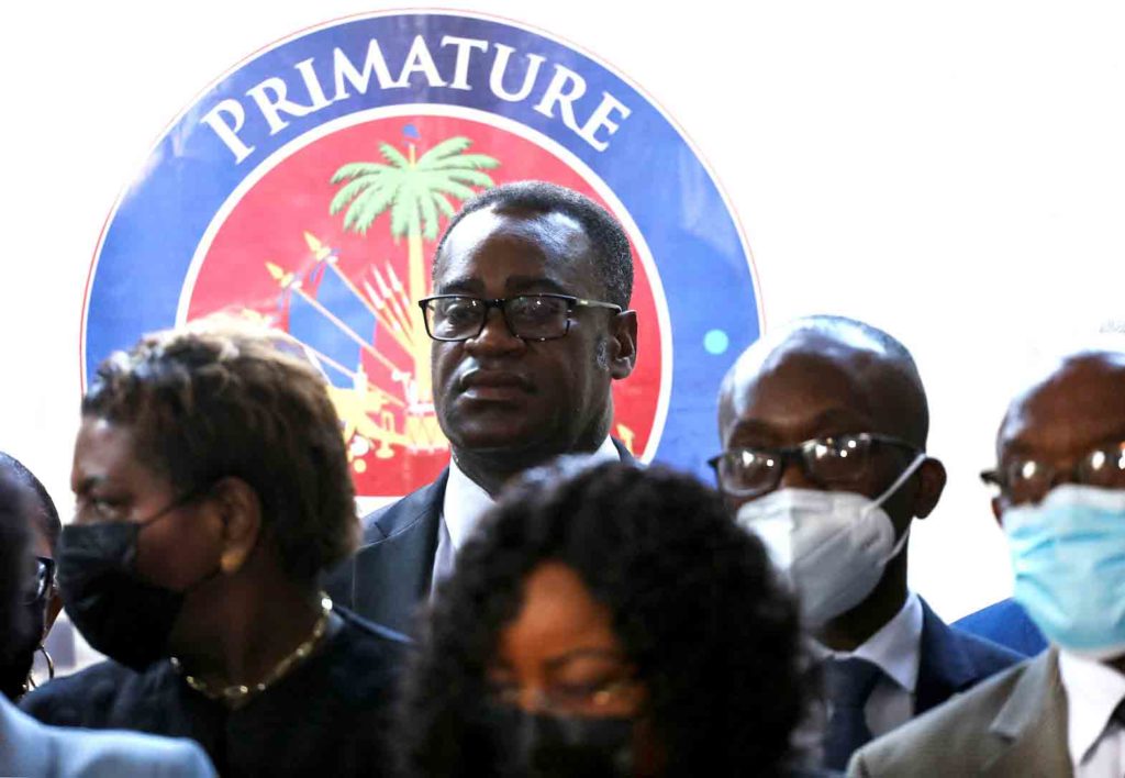 Haitian Minister of Justice and Public Security Berto Dorce listens as Prime Minister Ariel Henry addresses the nation and calls for renewed efforts to organize elections in the Caribbean nation as his adversaries push for the creation of a transition government to tackle escalating gang violence. in Port-au-Prince, Haiti February 7, 2022. REUTERS/Ralph Tedy Erol/File Photo