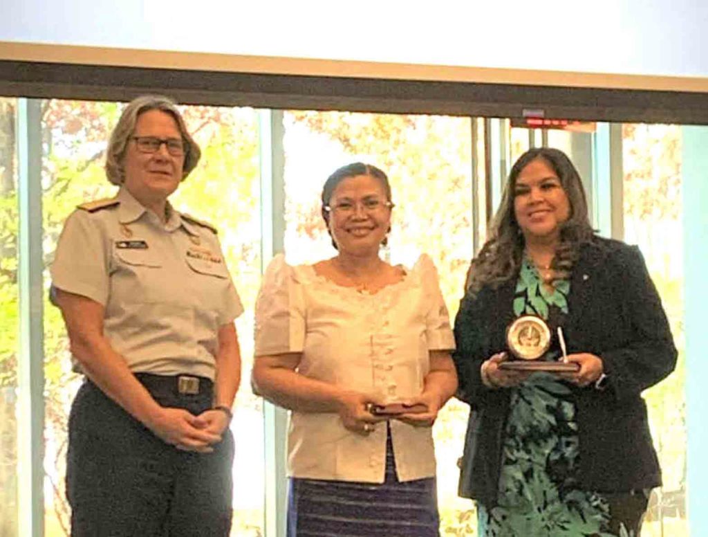    Awardee Mary Jean Silva (center) in Washington DC, with U.S. Coast Guard Commander A