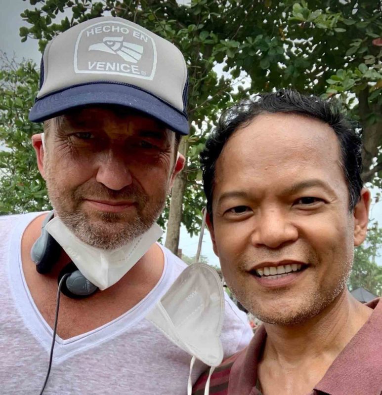 Filipino American actor and filmmaker Ariel Felix (right) with Gerard Butler while filming “Plane.” TWITTER