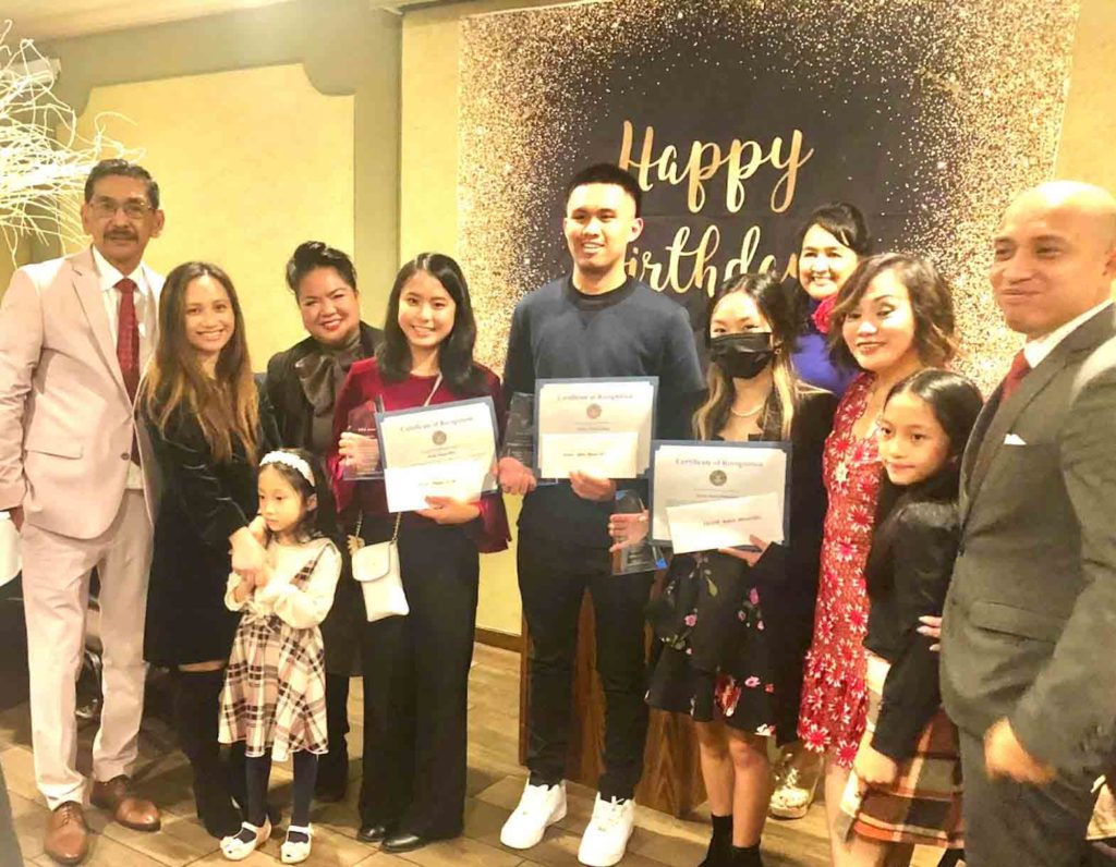 Tala Awards organizers Edd and Vicky Aguilar Palomar (first and ninth from left) with awardees (center) Jizelle Oliva, John Bocaling, Krista Mananquil and their families. CONTRIBUTED