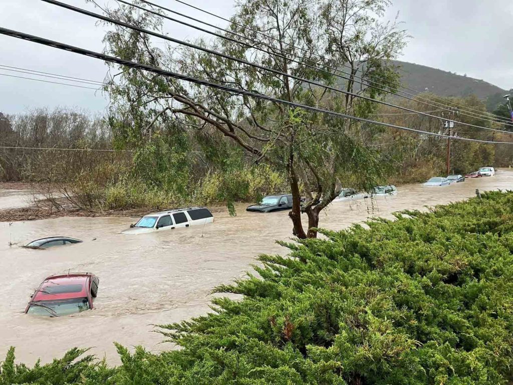 Cars are seen submerged in flood waters in Morro Bay, California, U.S., January 9, 2023 in this picture obtained from social media. Carolyn Krueger/via REUTERS
