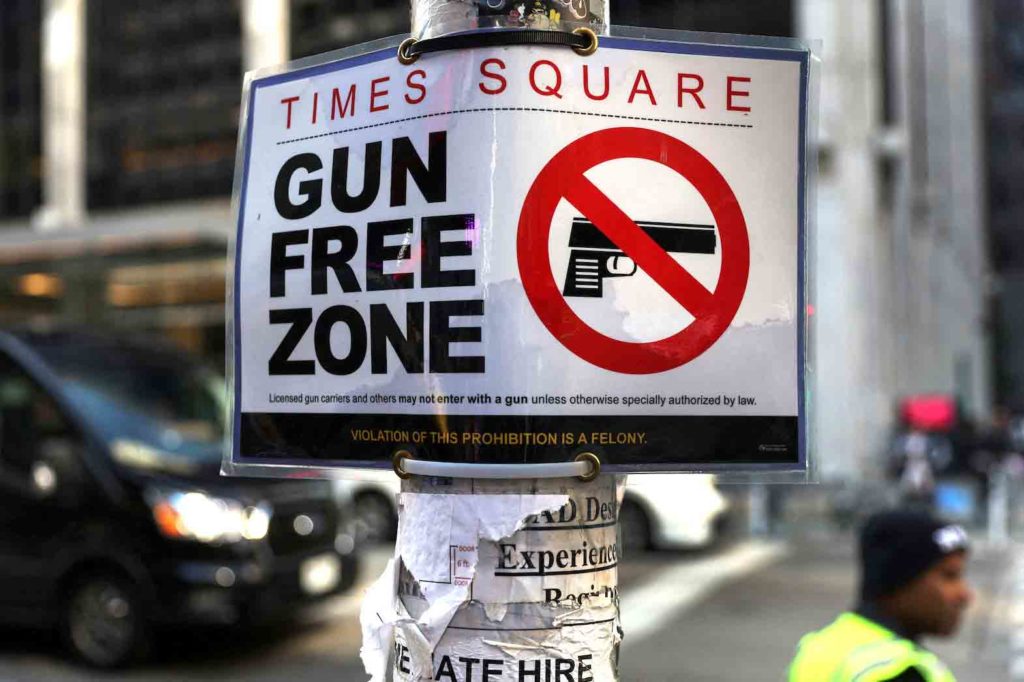 A Times Square Gun Free Zone sign hangs from a light pole on 6th avenue in New York City, U.S., October 10, 2022. REUTERS/Shannon Stapleton