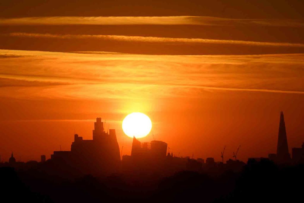 The sun rises behind the London skyline as a second heatwave is predicted for parts of the country, Richmond Park, London, Britain, August 8, 2022. REUTERS/Toby Melville