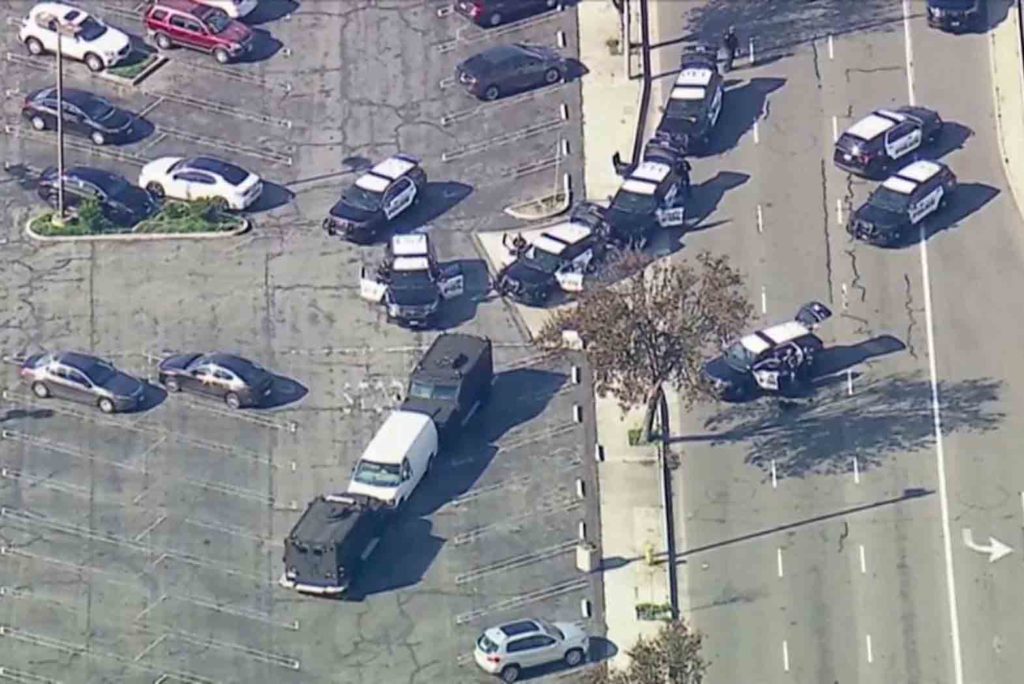Police used armored vehicles to block a white cargo van at a Torrance, California, parking lot, where suspected Monterey Park mass shooter was found dead from a self-inflected gunshot wound. ABC AFFILIATE KABC/VIA REUTERS
