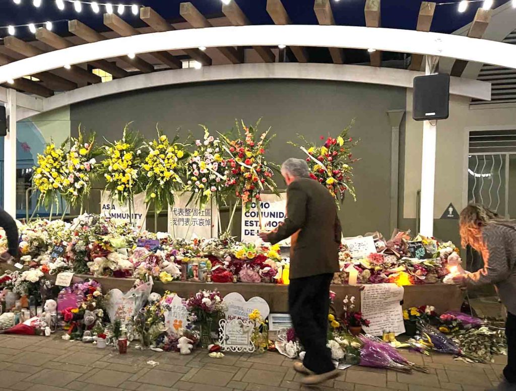 Flowers abound, candles glow and messages of hope pour out for the Half Moon Bay community at the Jan. 31 Our Lady of the Pillar and Coastside Interfaith Community memorial on Main Street.  NENAR NICOLAS