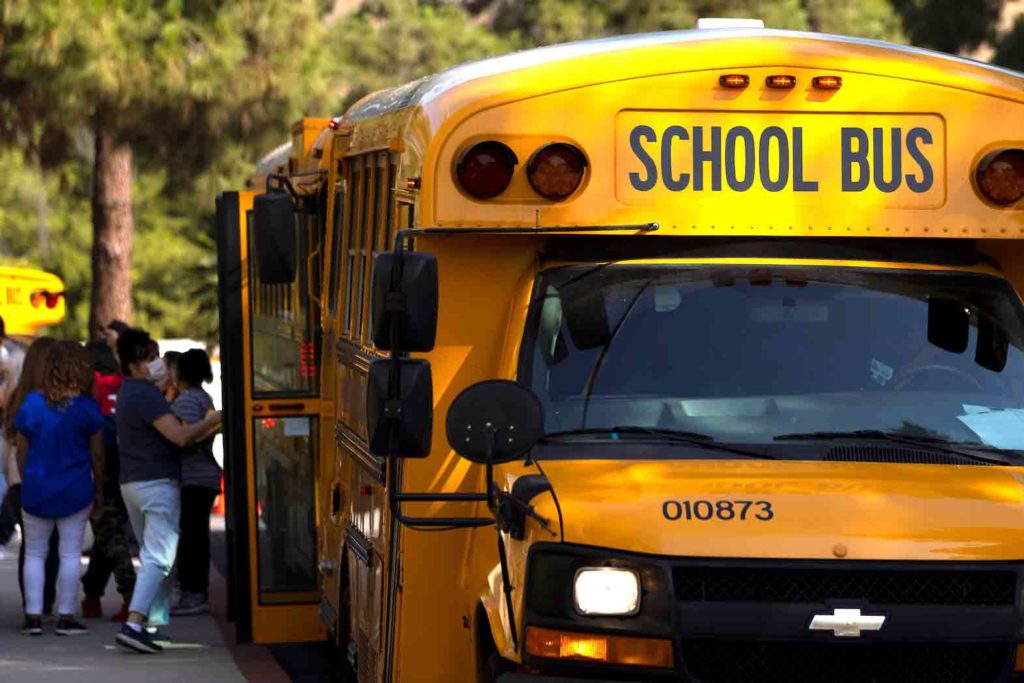 School buses line up outside Woodrow Wilson Senior High School as students return to in-person classes in Los Angeles, California, U.S., August 30, 2021. REUTERS/Mike Blake
