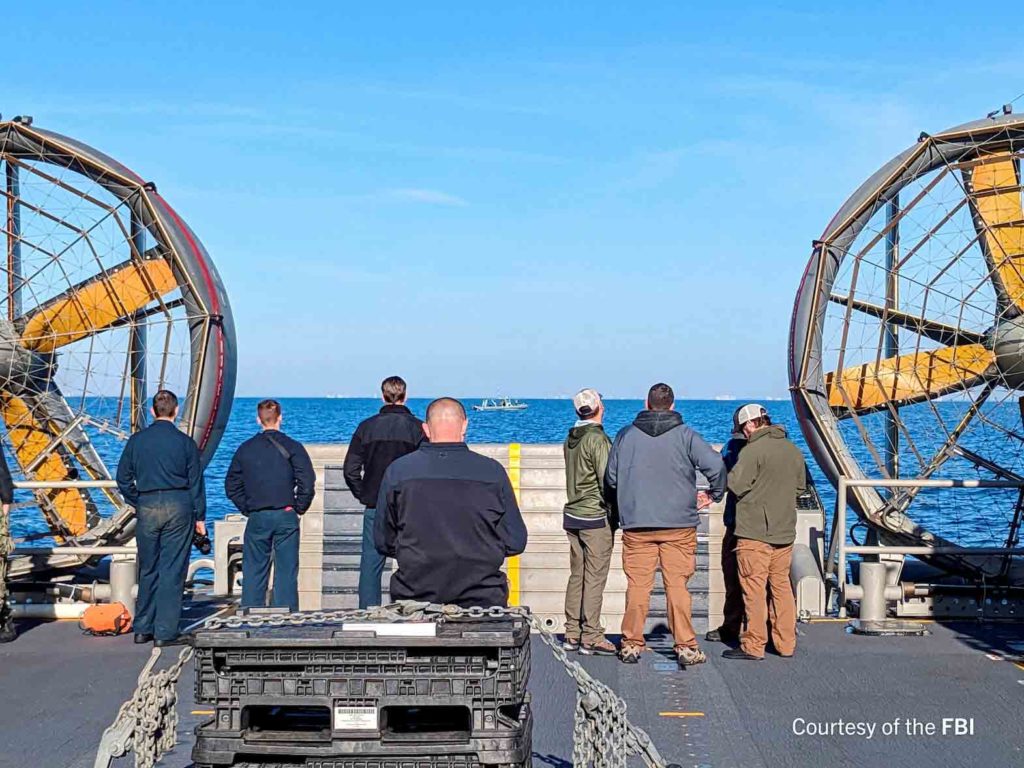 An undated U.S. Federal Bureau of Investigation handout photo taken aboard the USS Carter Hall off South Carolina shows FBI Special Agents assigned to the bureau’s Evidence Response Team ready to process material recovered from the high-altitude Chinese balloon that was shot down by a U.S. military jet off the coast of South Carolina, in this image released by the FBI in Washington, U.S. February 9, 2023. FBI/Handout via Reuters