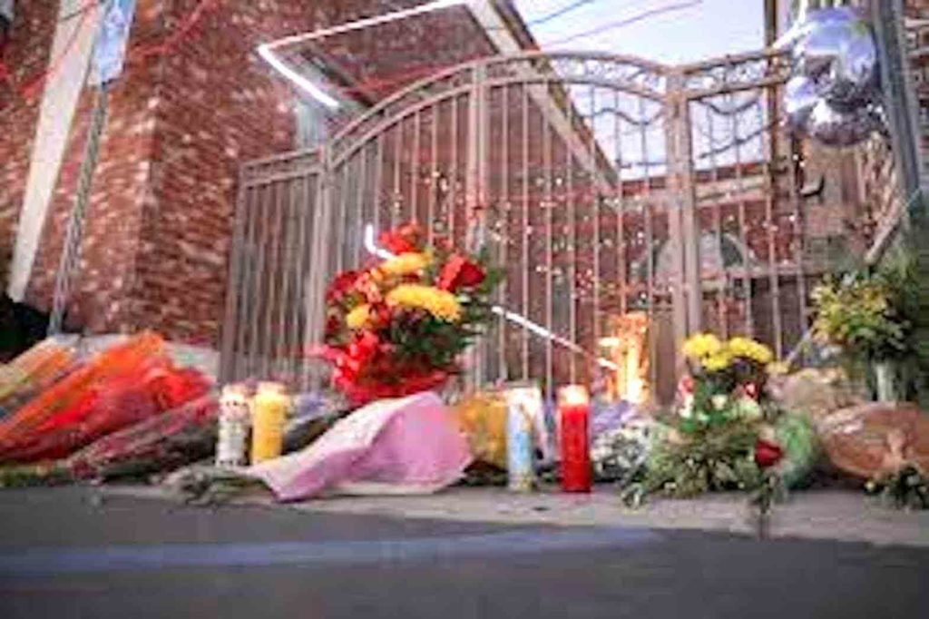Flowers and candles are left outside the entrance of the Star Ballroom Dance Studio after a mass shooting during Chinese Lunar New Year celebrations in Monterey Park, California, U.S. January 23, 2023. REUTERS/David Swanson