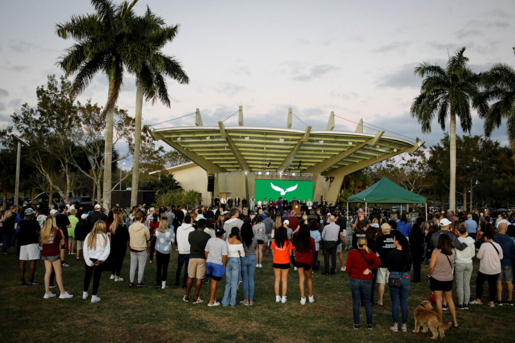 People attend a memorial service on the five-year anniversary since gunman Nikolas Cruz opened fire at Marjory Stoneman Douglas High School killing 14 students and three staff members, in Parkland, Florida, U.S., February 14, 2023. REUTERS/Marco Bello