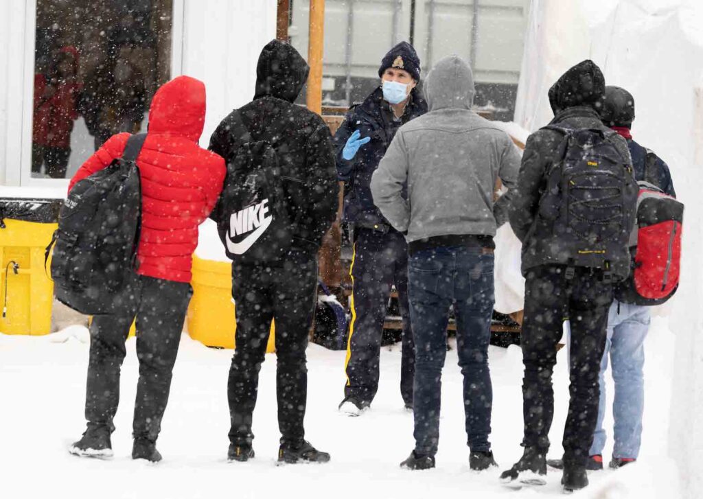 Asylum seekers crossing into Canada from the U.S. in Champlain, New York, U.S., February 28, 2023. REUTERS/Christinne Muschi