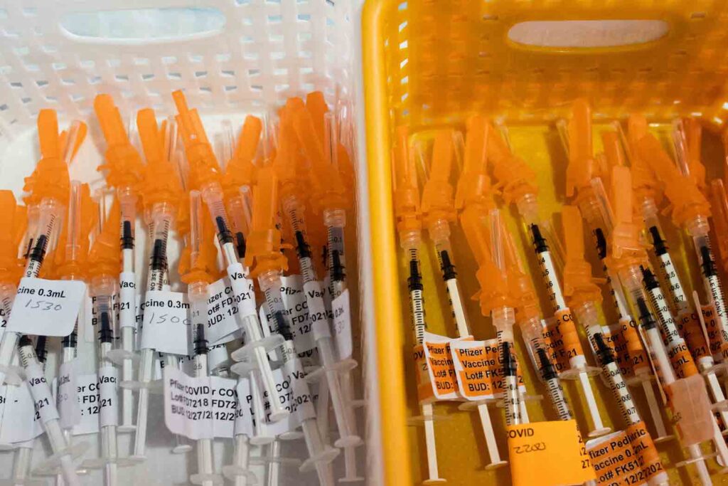 Syringes filled with the Pfizer BioTech coronavirus disease (COVID-19) vaccine are seen at Sparrow Laboratories Drive-Thru Services in Lansing, Michigan, U.S., December 27, 2021. REUTERS/Emily Elconin/File Photo