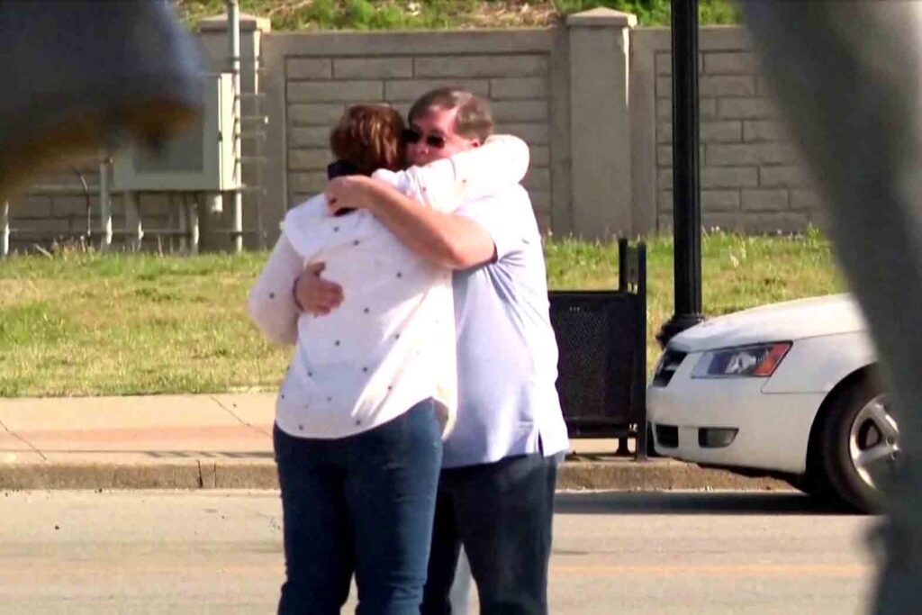 People embrace after an "active police situation" that included mass casualties at Old National Bank in Louisville, Kentucky, U.S. April 10, 2023 in a still image from video. ABC affiliate WHAS via REUTERS