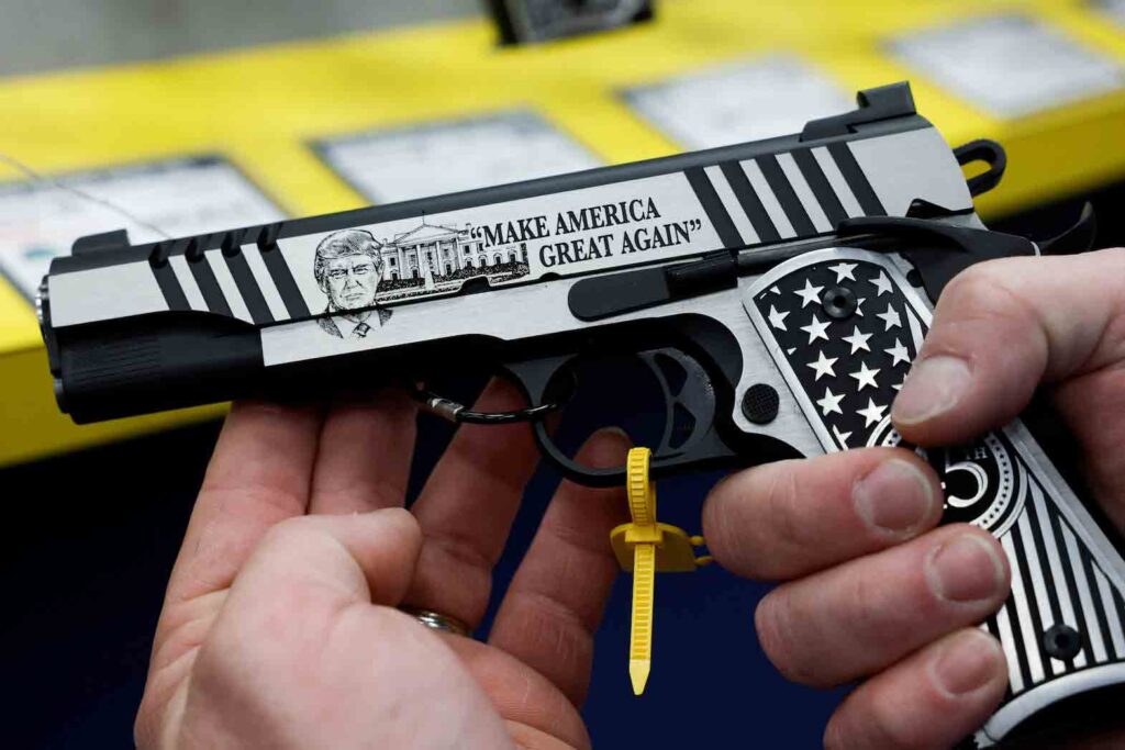 An attendee holds a gun with the image of former U.S. President Donald Trump at the National Rifle Association (NRA) annual convention in Indianapolis, Indiana, U.S., April 14, 2023. REUTERS/Evelyn Hockstein