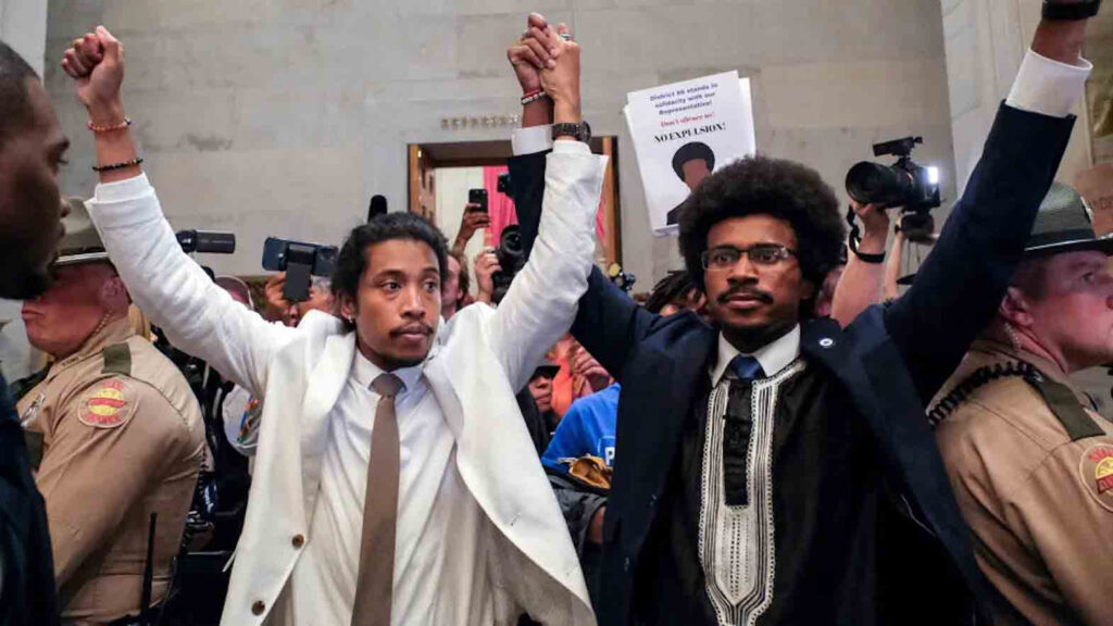 Filipino American lawmaker Justin Jones (left) and colleague Justin Pearson raise their hands after being expelled from their seats in the Tennessee House in Nashville Thursday. Kevin Wurm/REUTERS