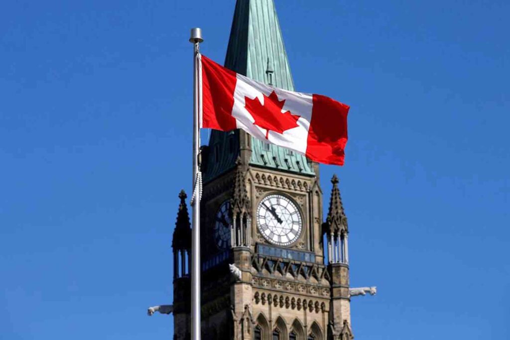 A Canadian flag flies in front of the Peace Tower on Parliament Hill in Ottawa, Ontario, Canada, March 22, 2017. Canada is allowing international graduates with recently expired or expiring post-graduation work permits (PGWP) to stay longer and gain valuable  work experience. REUTERS/Chris Wattie