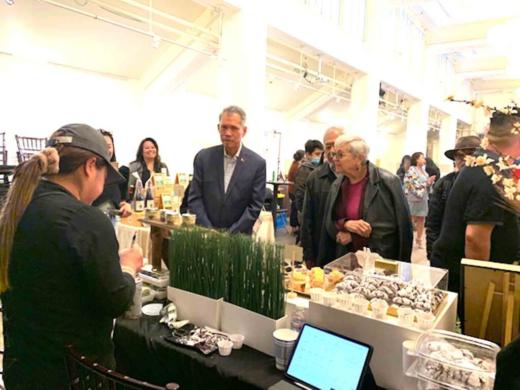 Scene from the first Friday of the “Filipino Food Market” on April 14  at the Kalayaan Hall of the Philippine Center in San Francisco, with Consul General Neil Ferrer, leading guests to food displays. The food market will hold two more runs at the Philippine Center’s Kalayaan Hall on April 21 and 28. CONTRIBUTED