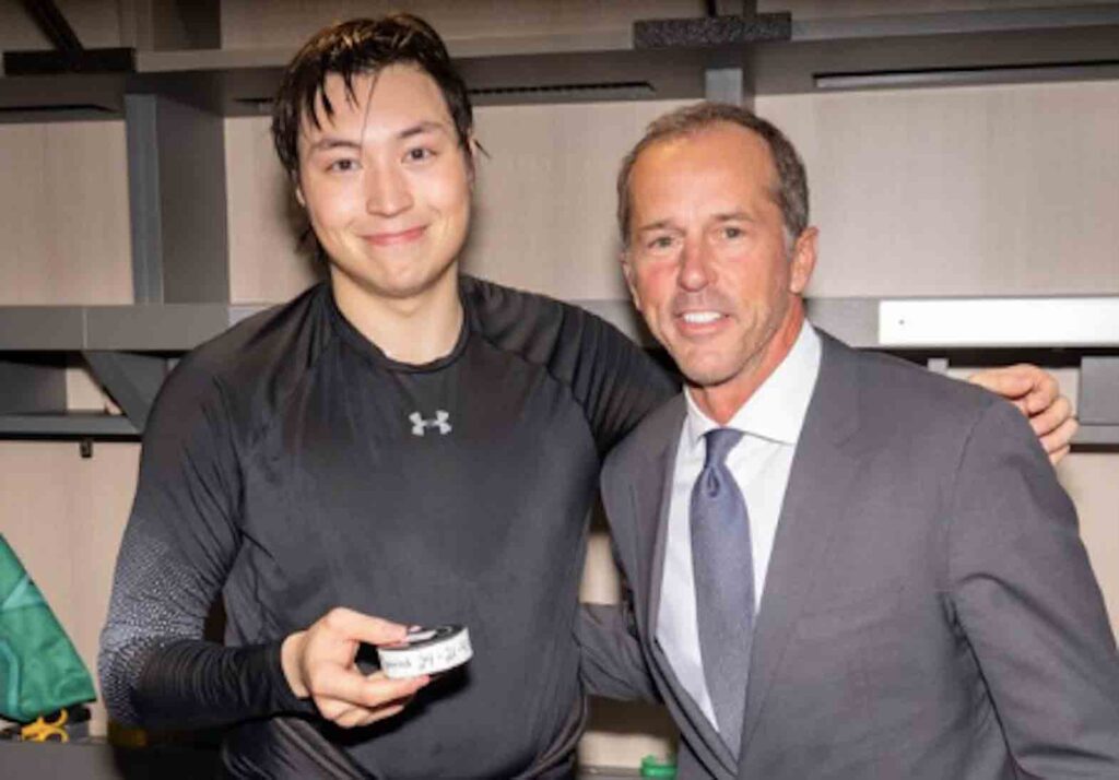 Holding the puck he used to score the record-breaker, Robertson poses for a post-game photo with Hockey Hall of Famer Mike Modano, whose record he broke. NHL