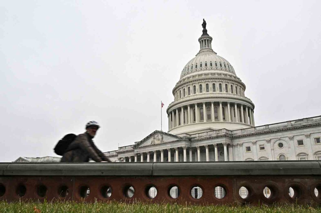 A cyclist passes by the U.S. Capitol building, on the morning of the first day of the 118th Congress in Washington, DC, U.S., January 3, 2023. REUTERS/Jon Cherry/File Photo