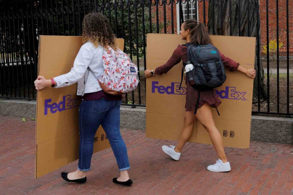 Students carry boxes to their dorms at Harvard University in Cambridge, Massachusetts, U.S., March 10, 2020. REUTERS/Brian Snyder/
