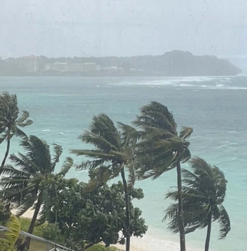 Trees sway in strong winds from typhoon Mawar in Tamuning, Guam, May 24, 2023 in this still image obtained from social media video. Video taken through a window. Instagram @rachel.j_____/via REUTERS