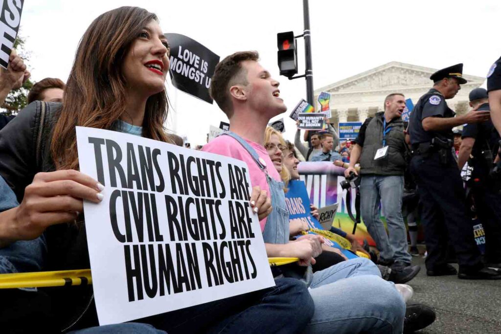 LGBTQ activists and supporters block the street outside the U.S. Supreme Court as it hears arguments in a major LGBT rights case on whether a federal anti-discrimination law that prohibits workplace discrimination on the basis of sex covers gay and transgender employees in Washington, U.S. October 8, 2019. REUTERS/Jonathan Ernst