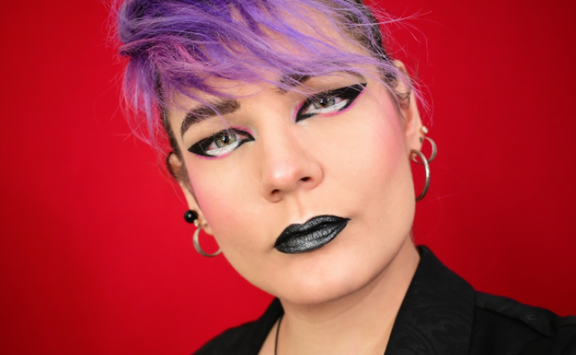 Woman wearing punk rock hairstyle and makeup