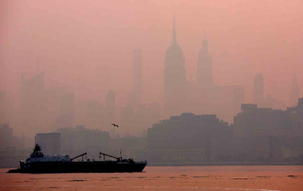 The Empire State Building in midtown Manhattan in New York City is pictured shortly after sunrise as haze and smoke caused by wildfires in Canada hangs over the Manhattan skyline in as seen from Jersey City, New Jersey, U.S., June 8, 2023. REUTERS/Mike Segar