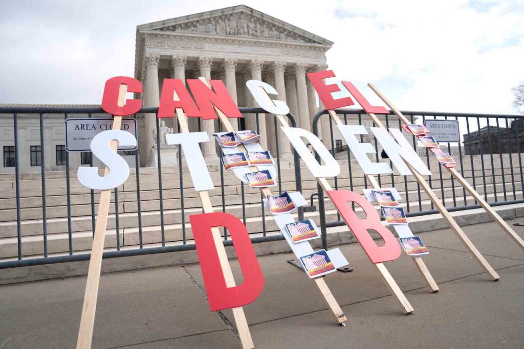 A sign calling for student loan debt relief is seen in front of the Supreme Court as the justices are scheduled to hear oral arguments in two cases involving President Joe Biden's bid to reinstate his plan to cancel billions of dollars in student debt in Washington, U.S., February 28, 2023. REUTERS/Nathan Howard