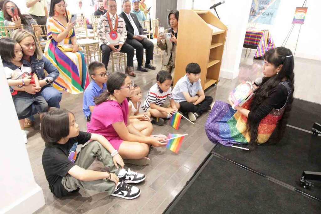 Author Ivy Wilcher reads from “My Rainbow Dads” to the children who attended the event at Sentro Rizal. CONTRIBUTED