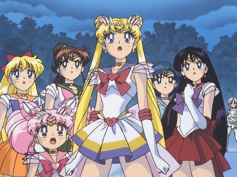 The Sailor Senshi, including Sailor Moon, standing together in their respective uniforms.
