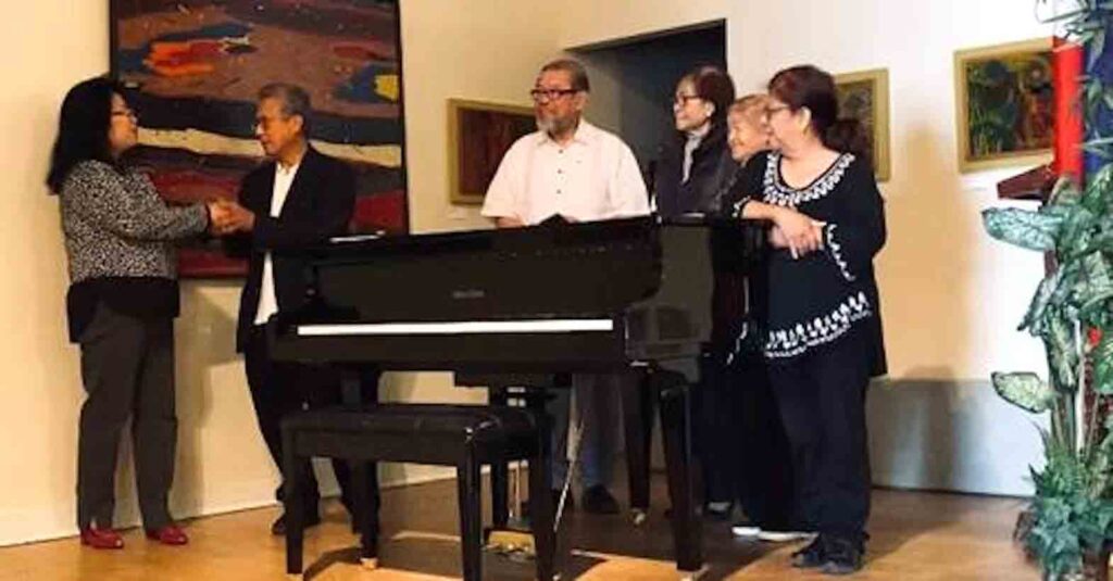 Members of Filipino American Council of Greater Chicago board of directors receiving a baby grand piano for the Rizal Center from Dr. C