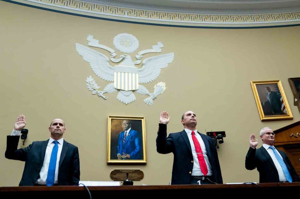 Ryan Graves, Americans for Safe Aerospace Executive Director, from left, U.S. Air Force (Ret.) Maj. David Grusch, and U.S. Navy (Ret.) Cmdr. David Fravor, are sworn in during a House Oversight and Accountability subcommittee hearing on UFOs, Wednesday, July 26, 2023, on Capitol Hill in Washington. (AP Photo/Nathan Howard)